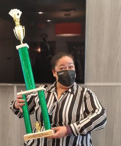 Michele holding the Solidus Games trophy