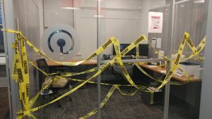 Dave's office is seen with copious amounts of yellow caution tape draped all around
